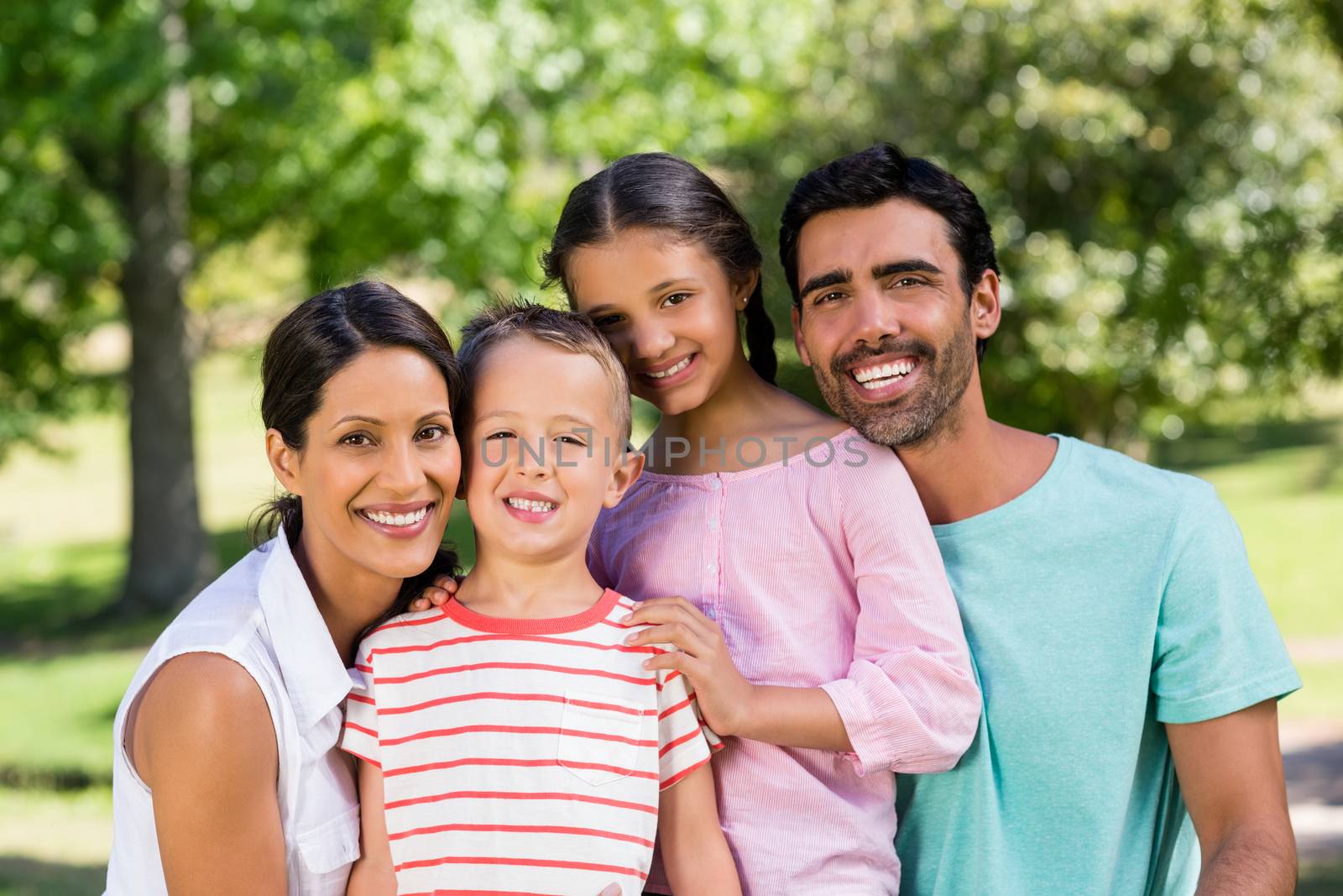 Portrait of happy family in park on a sunny day