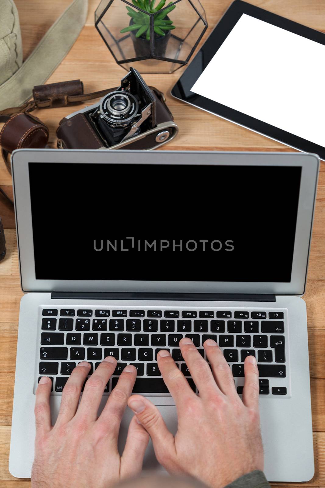 Photographer working over laptop in studio