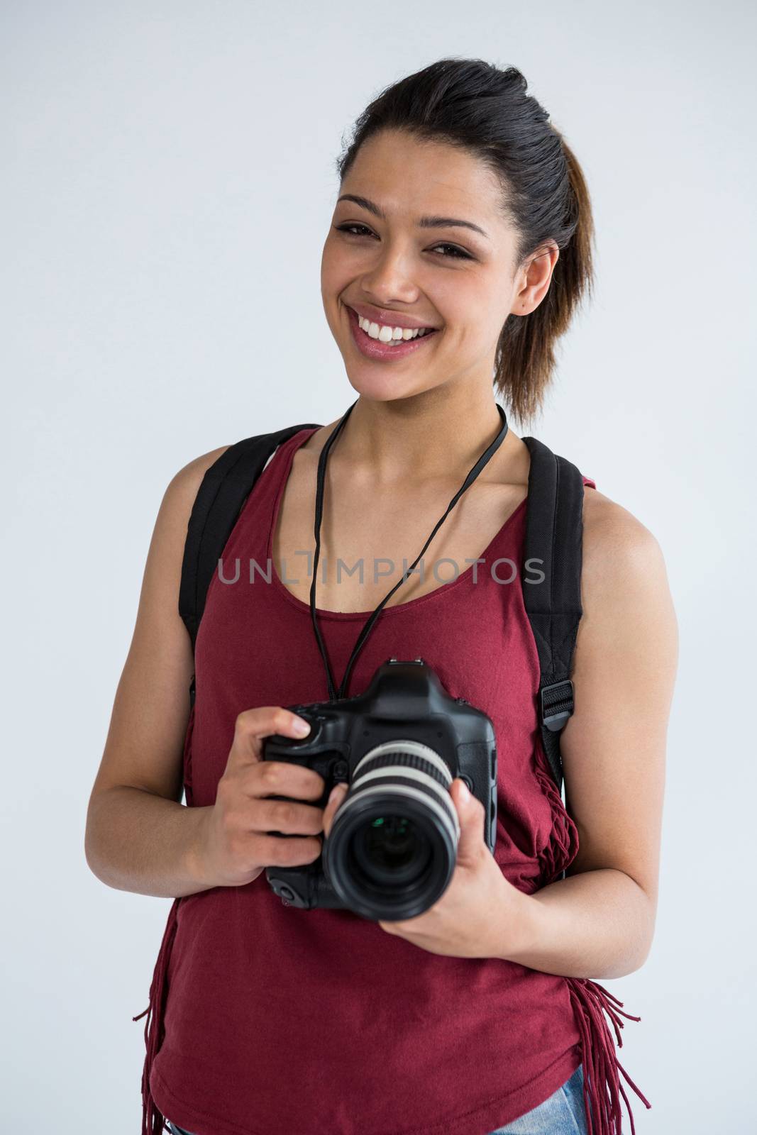 Happy female photographer standing in studio by Wavebreakmedia