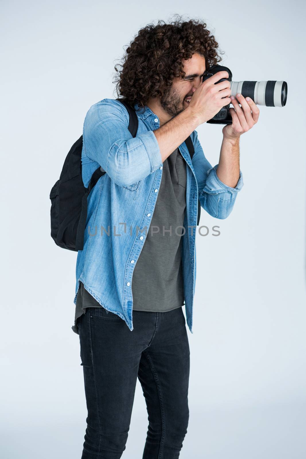 Male photographer with digital camera in studio