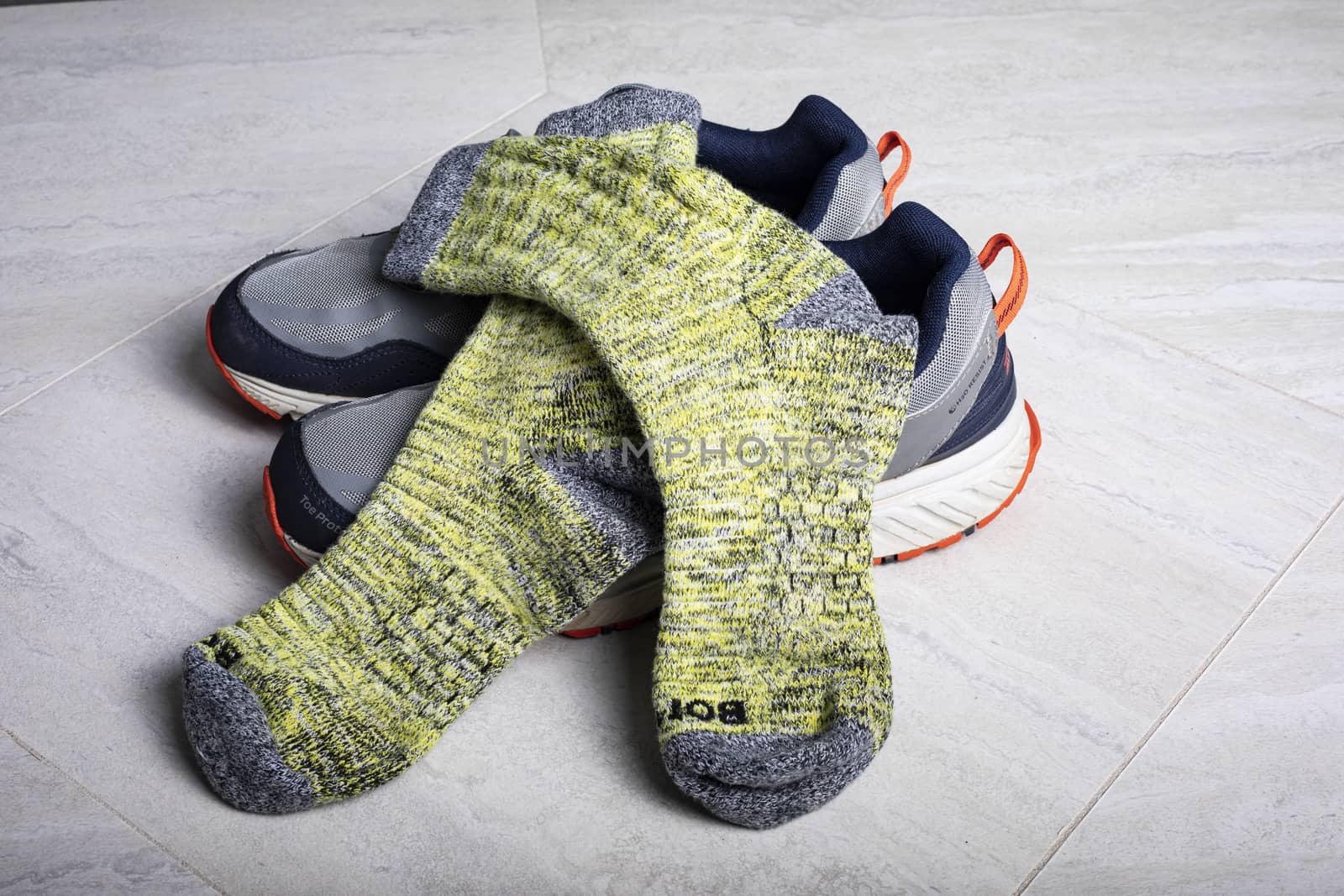 Yellow Bombas calf socks shown with athletic shoes. Honeycomb weave of arch is visible.