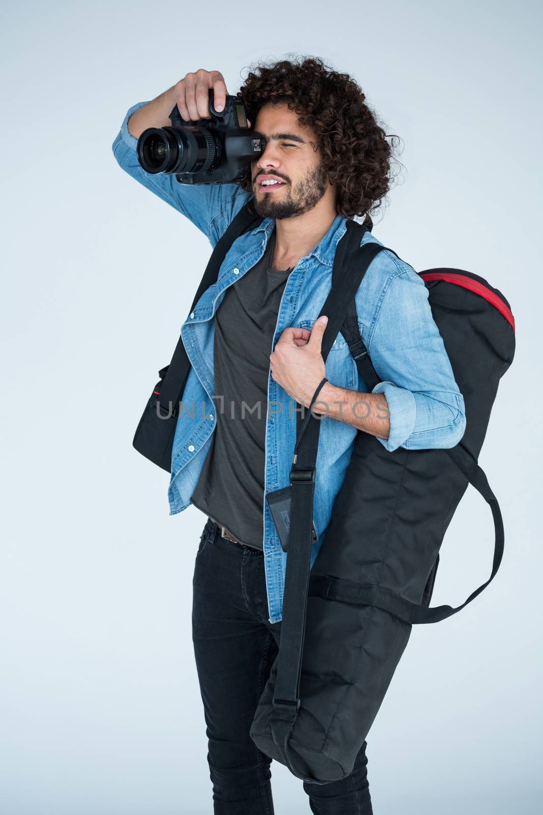 Male photographer with digital camera in studio