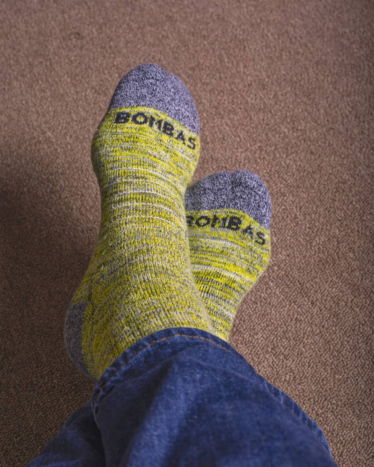 Yellow Bombas calf socks shown worn with blue jeans.