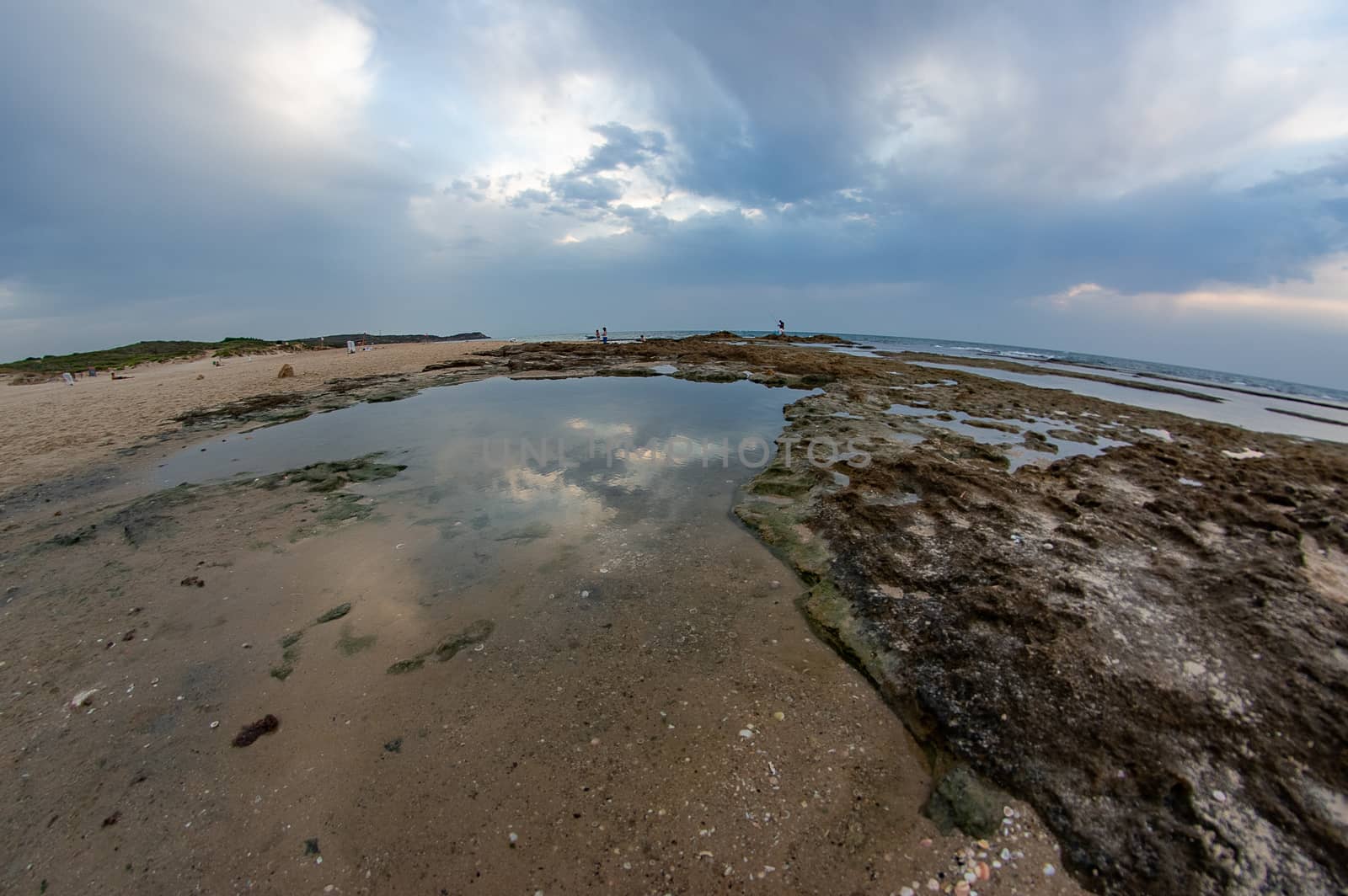 Dramatic clouds under water and windy weather sunset