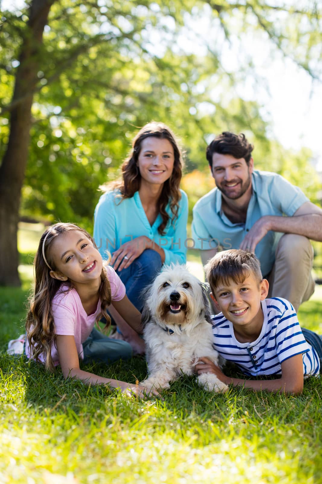 Portrait of happy family enjoying in park on sunny a day