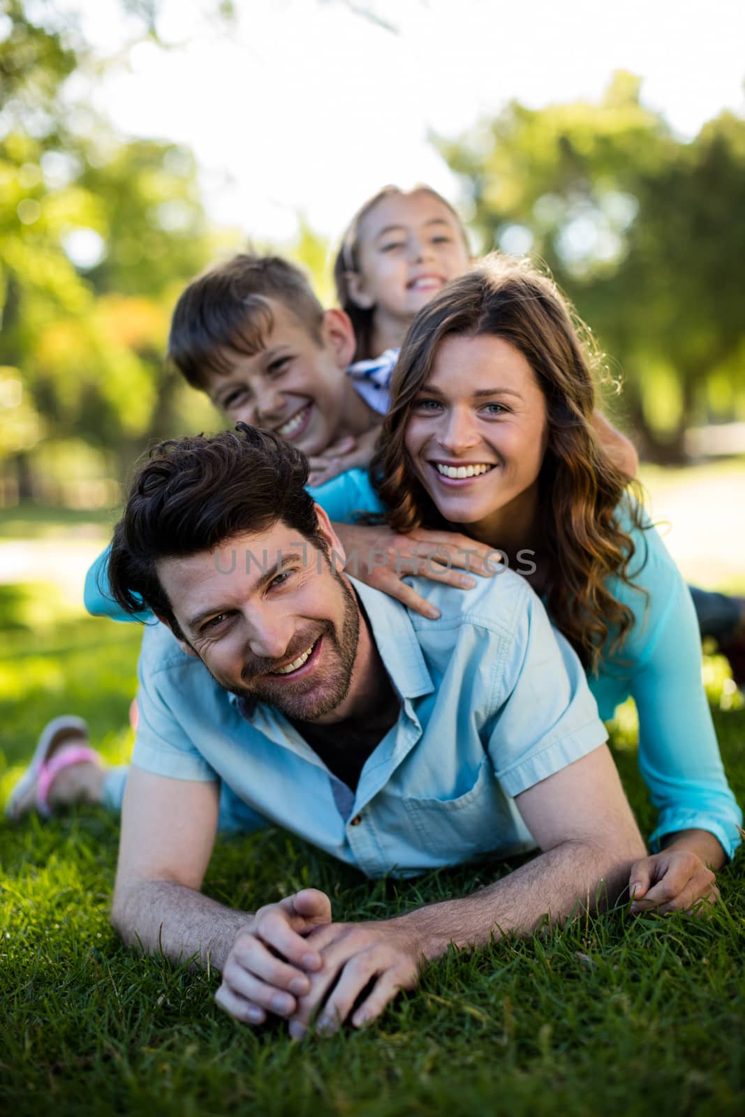 Portrait of happy family playing in park by Wavebreakmedia