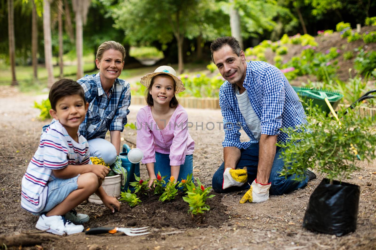 Happy family gardening together by Wavebreakmedia