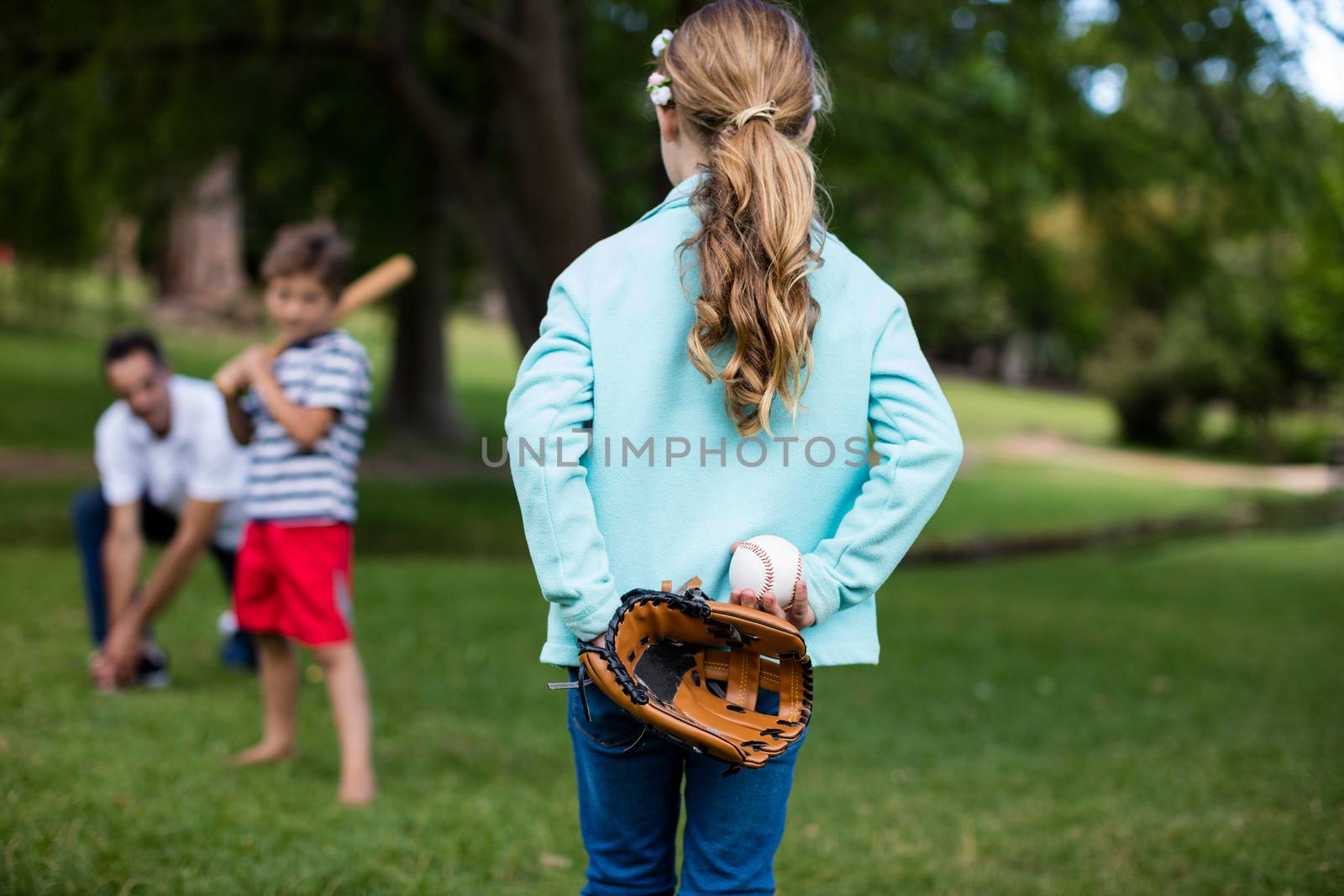 Family playing baseball in the park by Wavebreakmedia