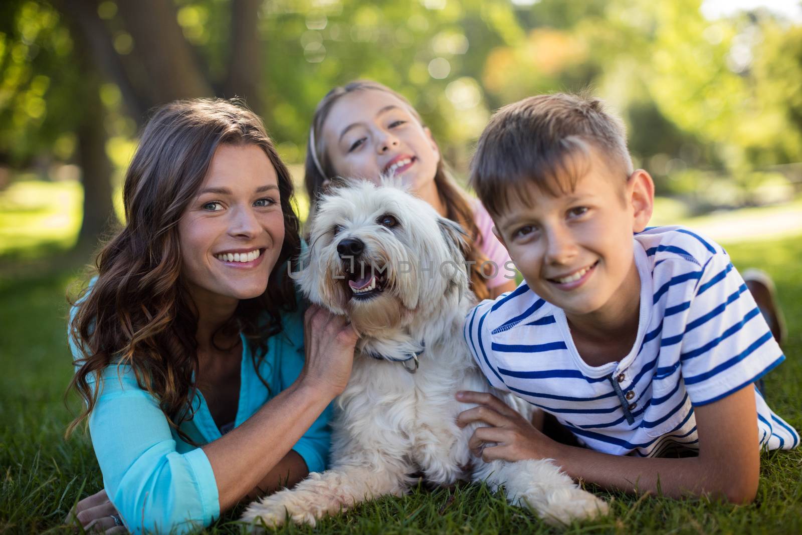 Portrait of happy family enjoying in park on sunny a day