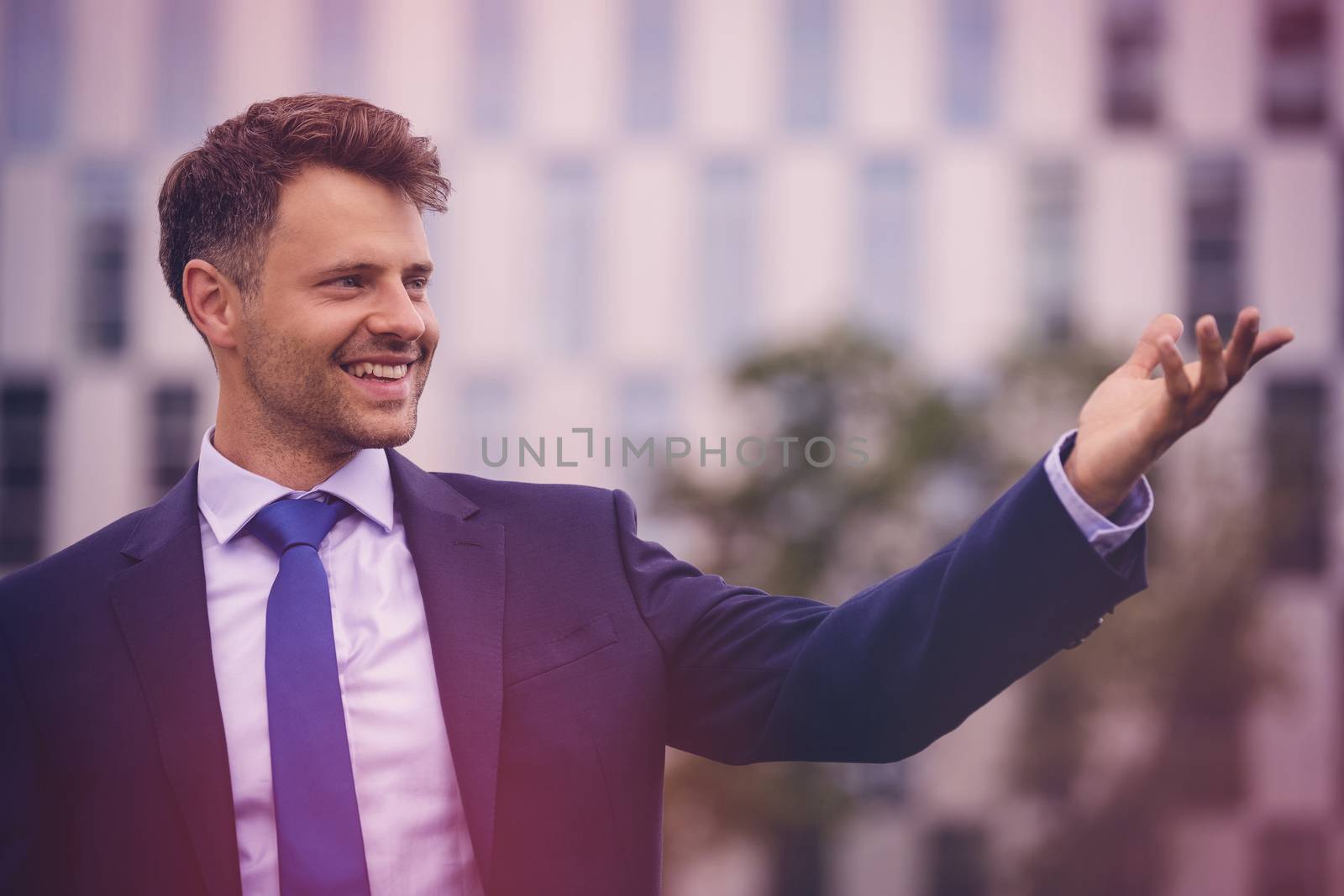 Close up of handsome businessman gesturing outdoors