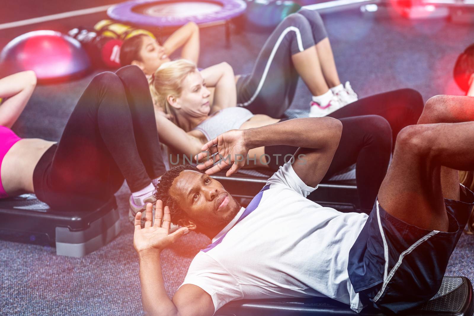 Group of people working their abs in gym