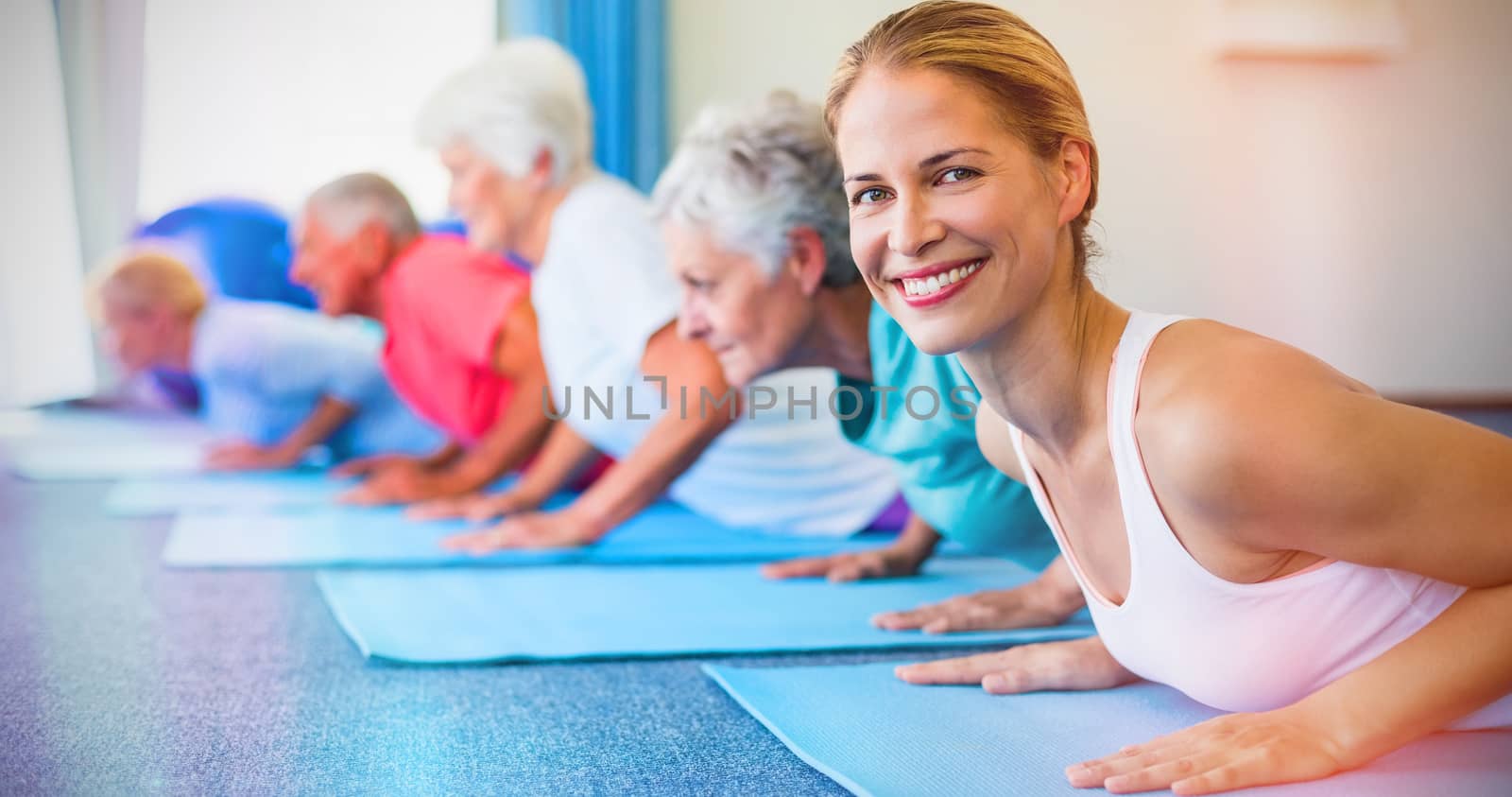Portrait of instructor performing yoga with seniors by Wavebreakmedia