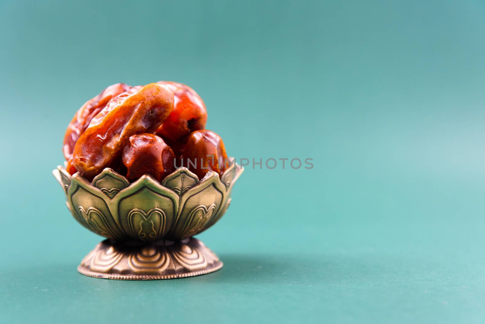 Ramadan, Dates in golden bowl vintage style on black green background