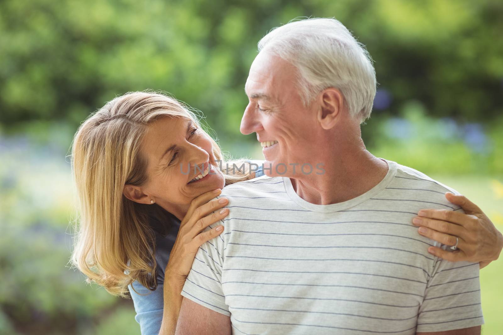 Smiling senior couple embracing outdoors