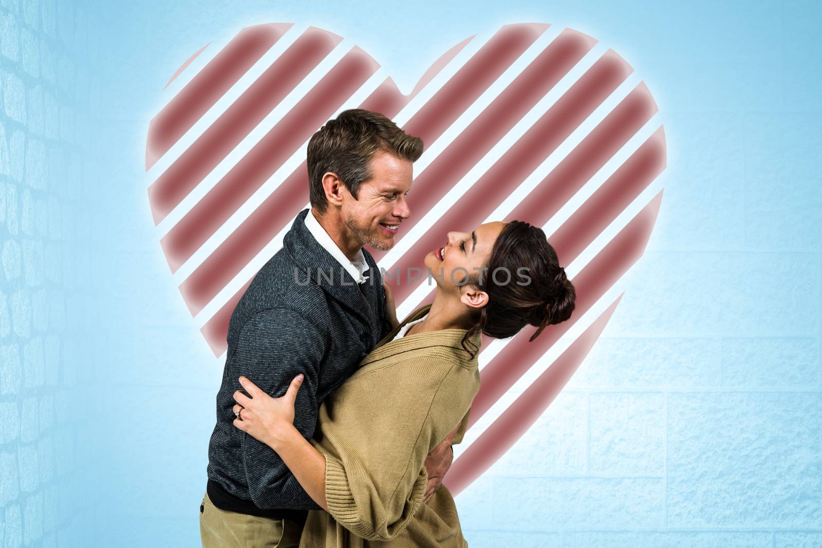 Composite image of happy romantic couple hugging by Wavebreakmedia