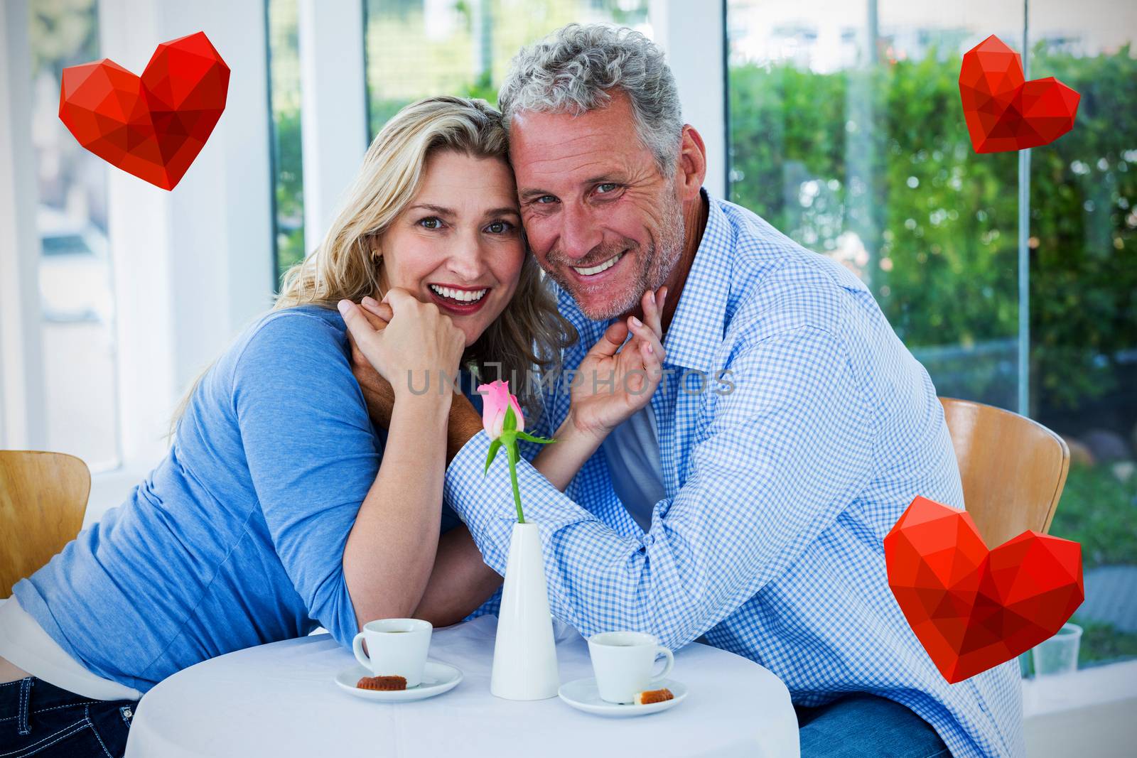 Heart against portrait of romantic couple in restaurant 3d