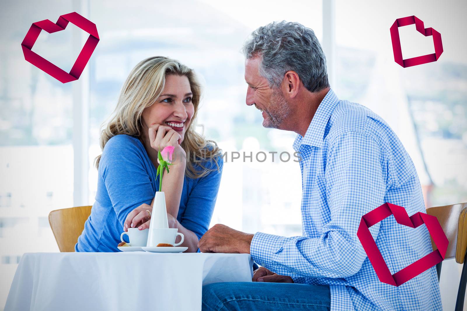 Heart against romantic couple sitting in restaurant 3d