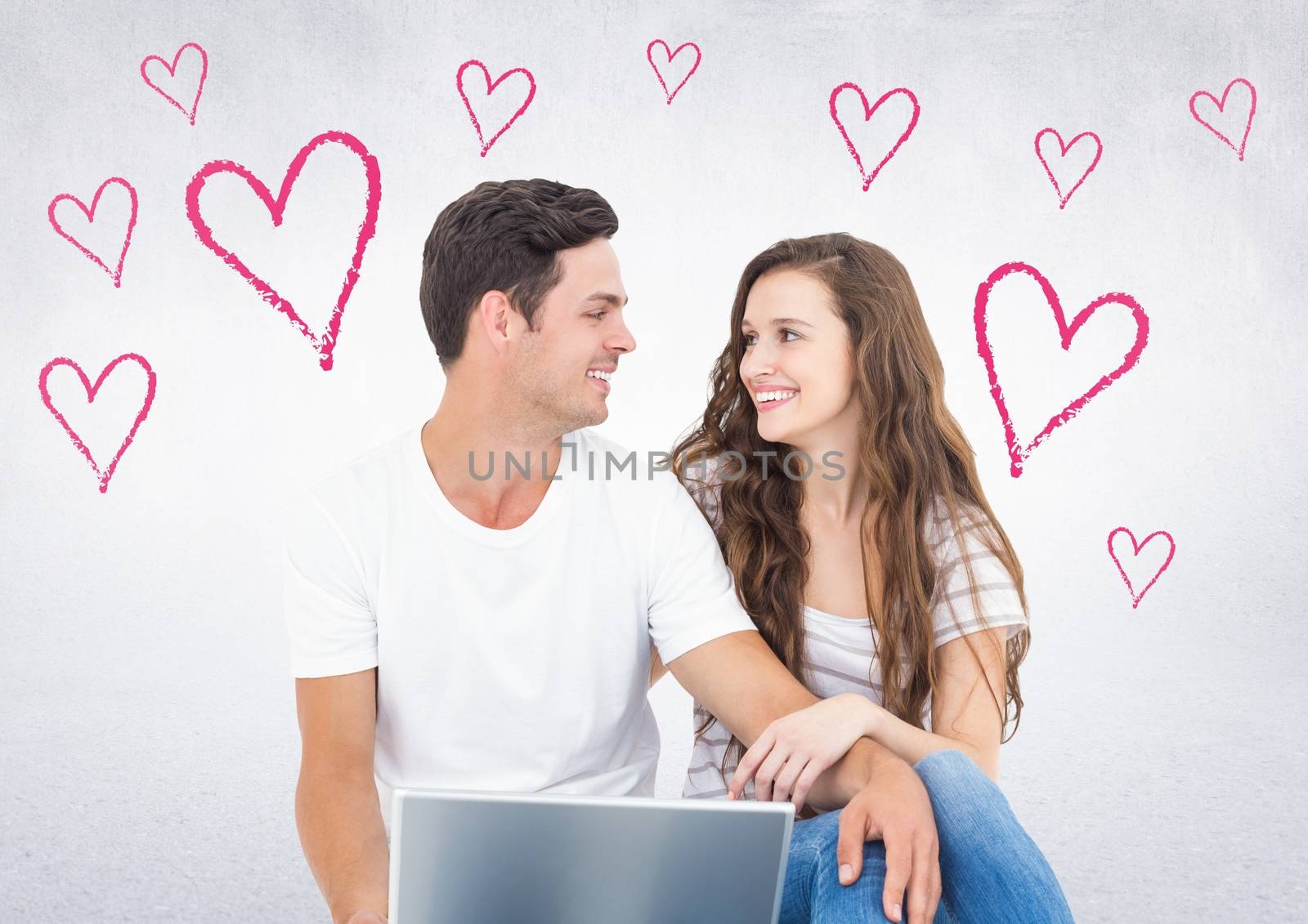 Romantic couple sitting against white background with pink heart shapes