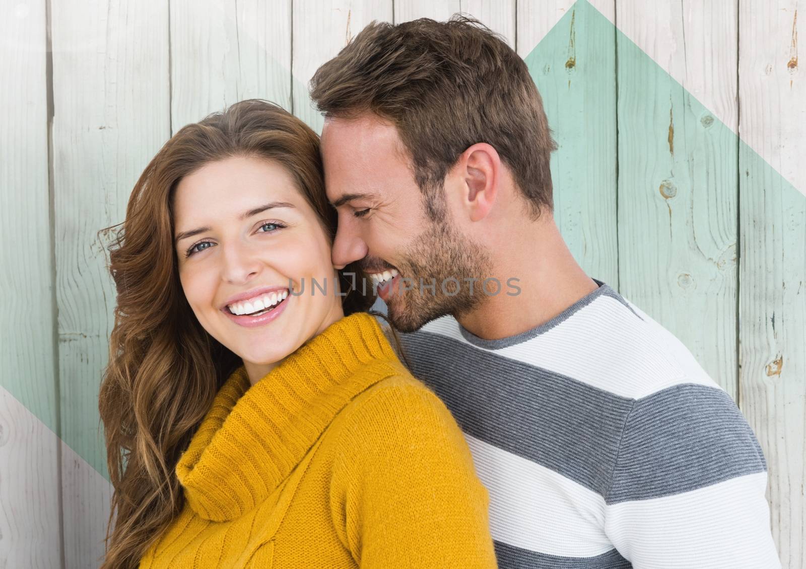 Couple embracing each other against wooden background by Wavebreakmedia
