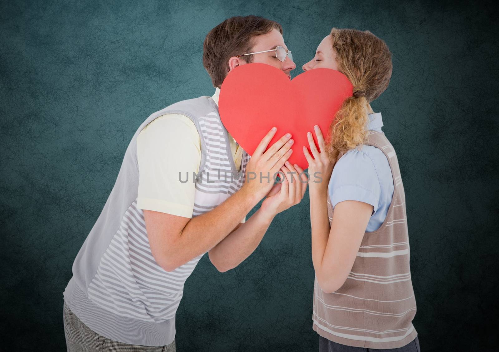 Romantic couple kissing behind heart by Wavebreakmedia