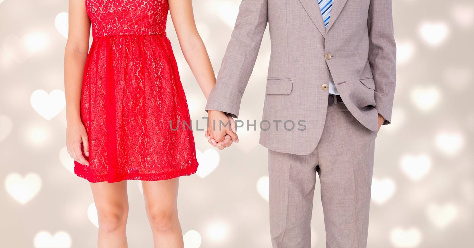 Mid-section of romantic couple holding hands