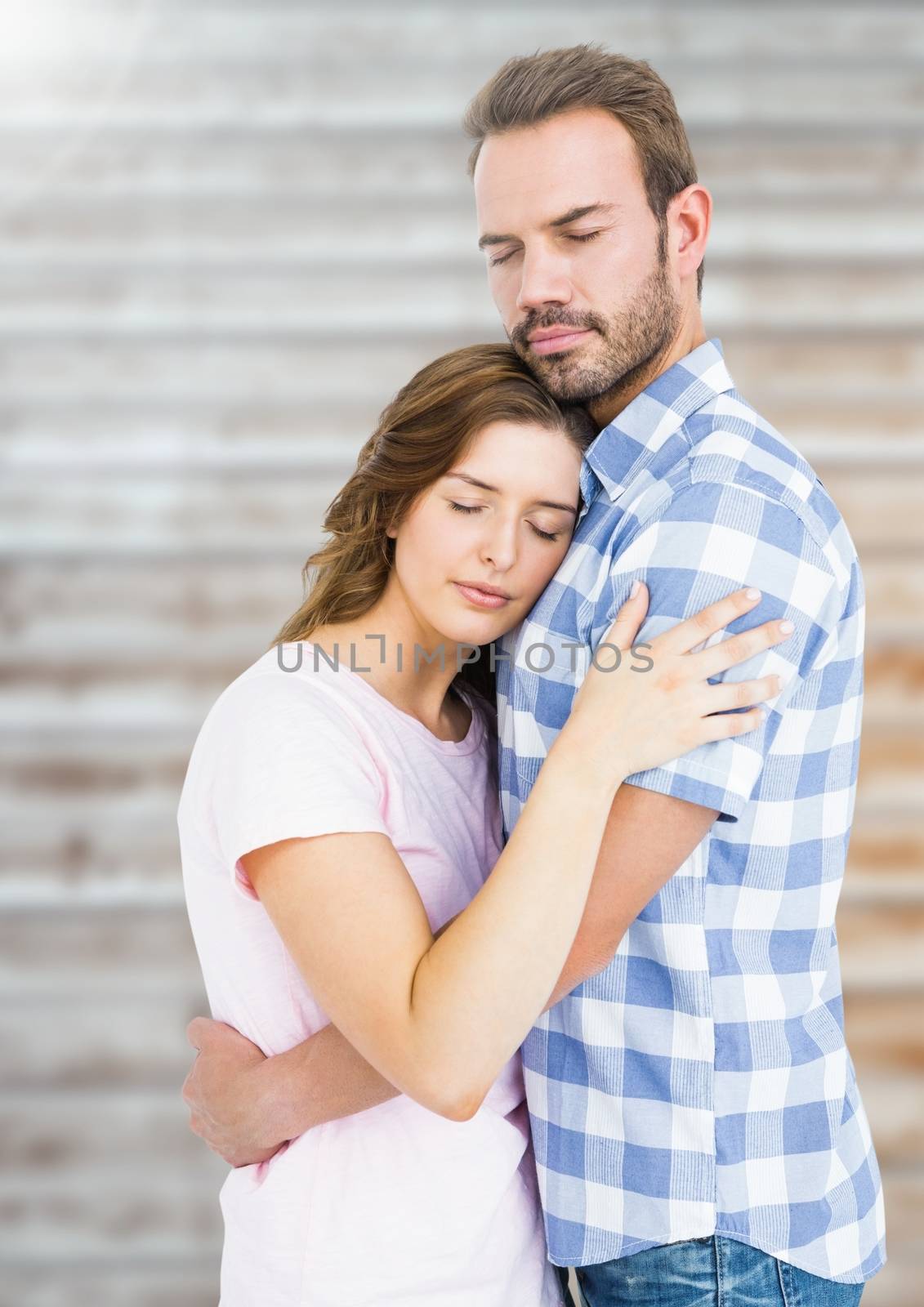 Romantic couple embracing each other against blur background