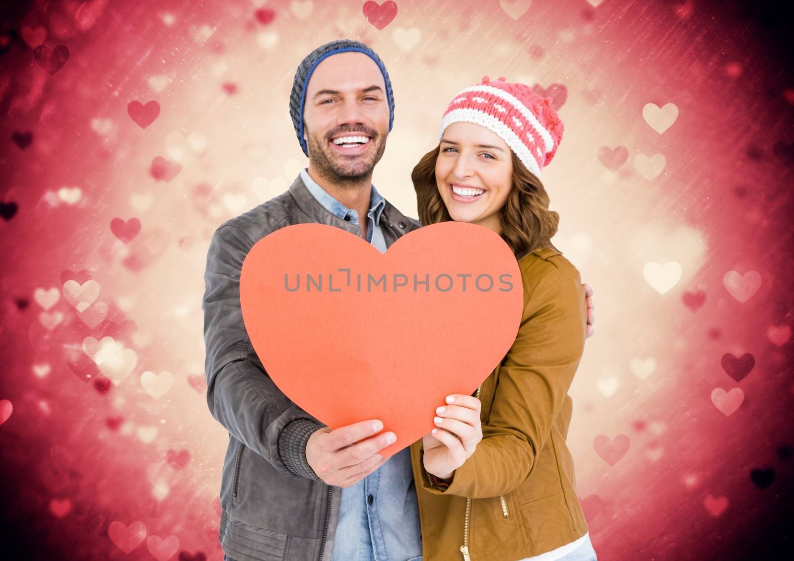 Romantic couple holding a heart against digitally generated background