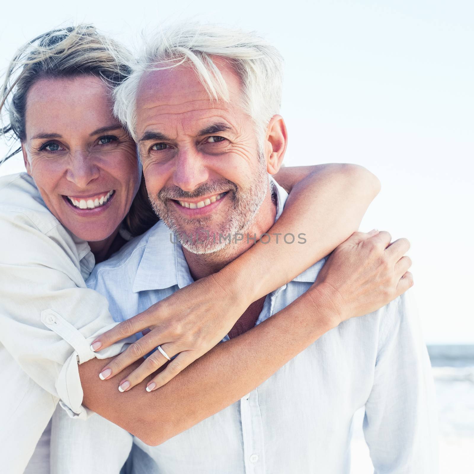 Attractive married couple posing at the beach by Wavebreakmedia
