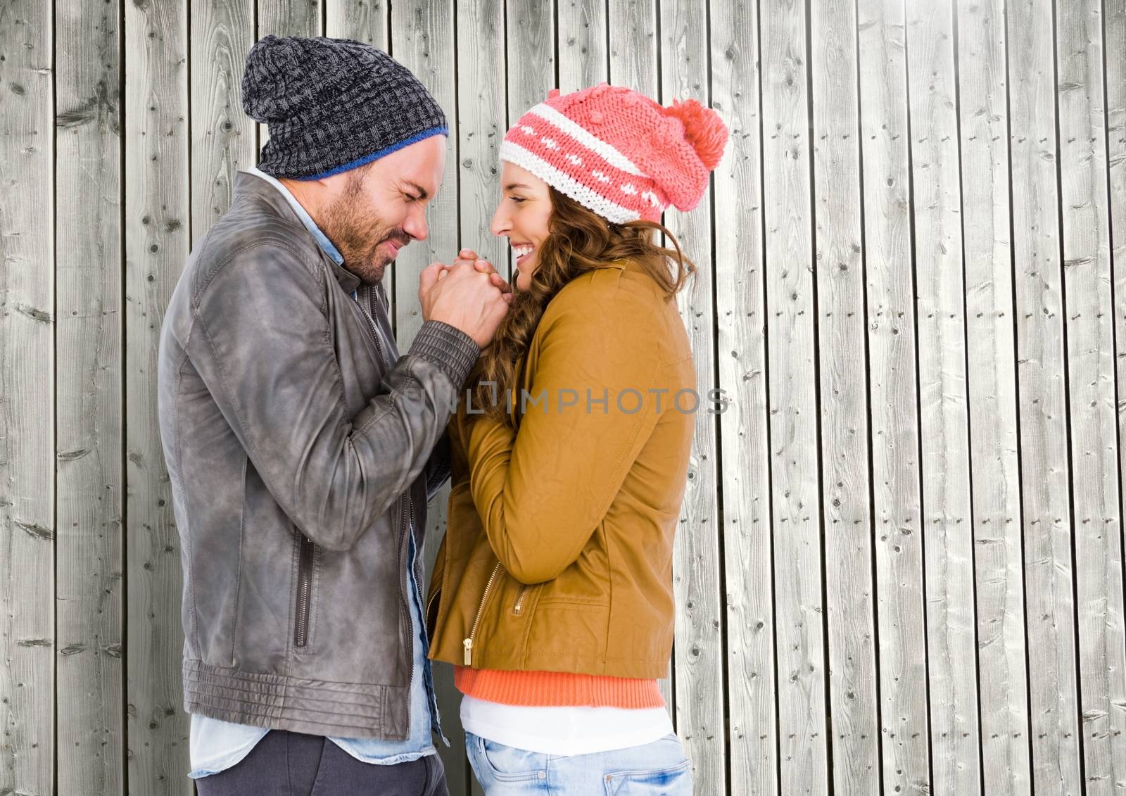 Romantic couple having fun together against wooden background