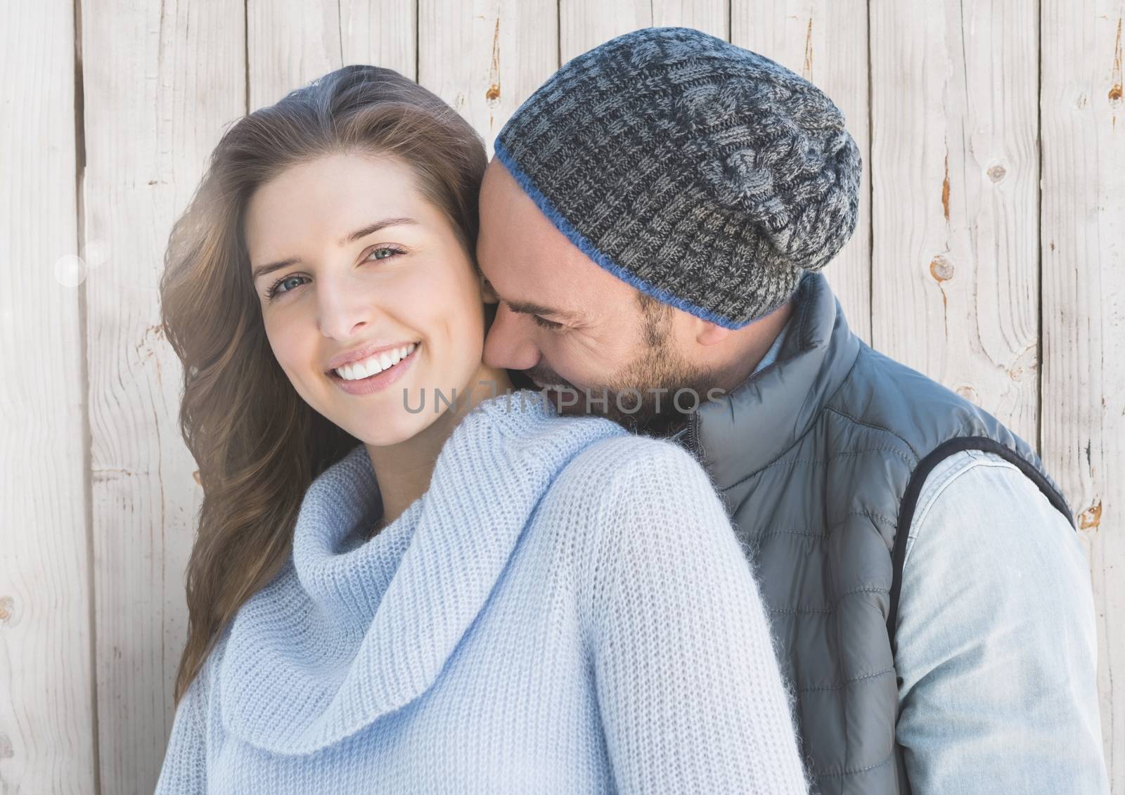 Romantic couple embracing each other against wooden background