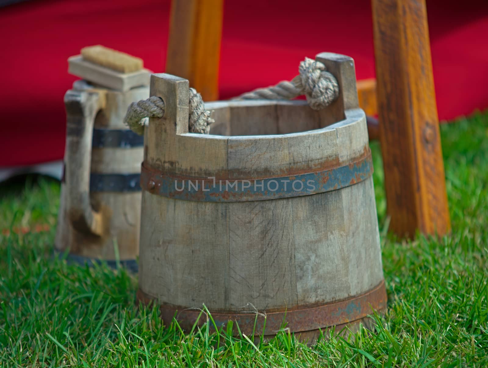 Medieval wooden bucket standing on grass