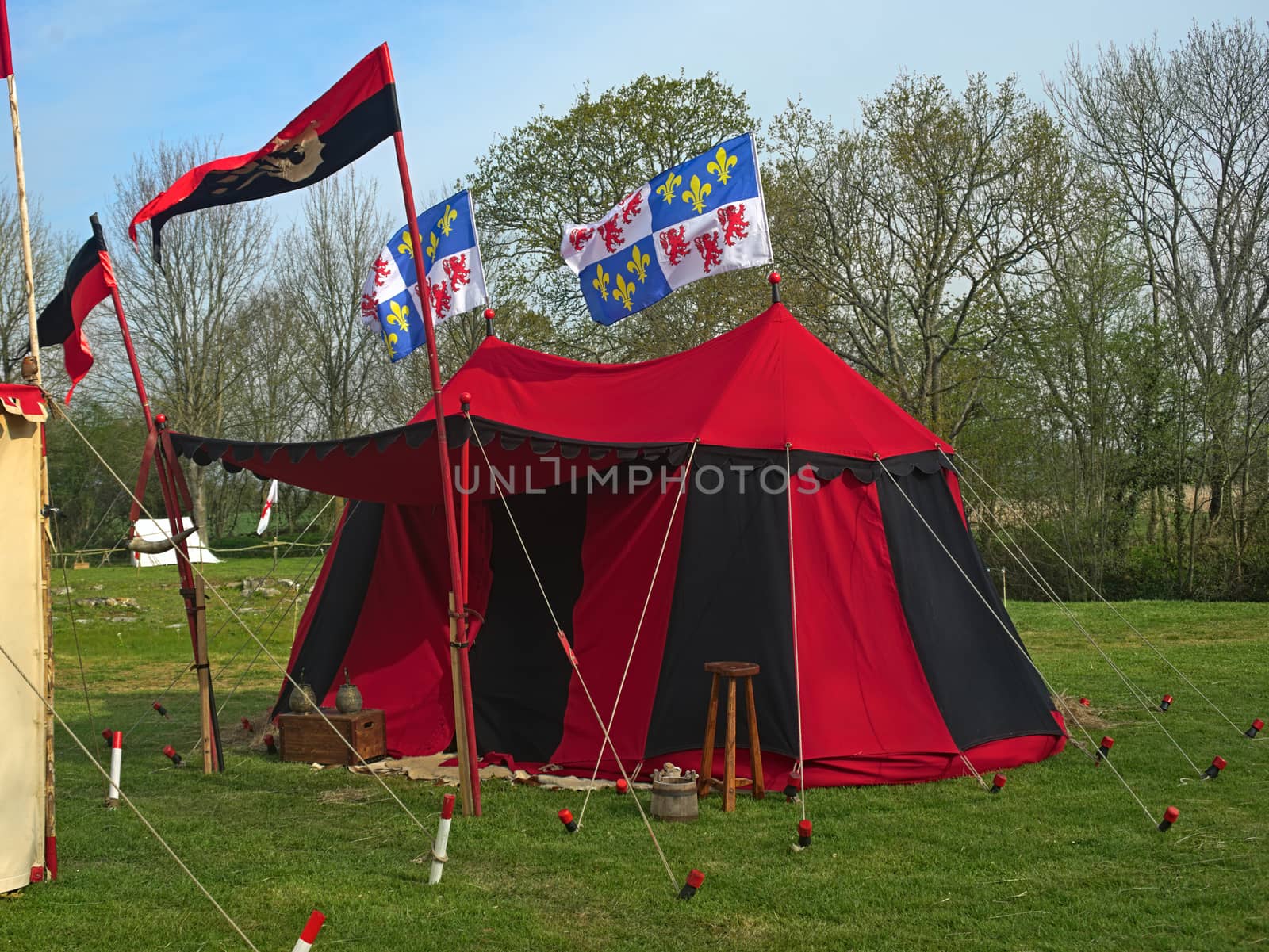 Medieval red and black war tent with normandy flags waving by sheriffkule