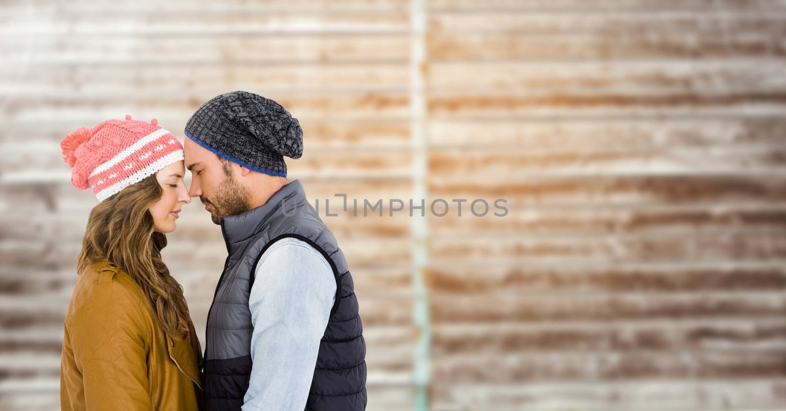 Romantic couple embracing each other against wooden background