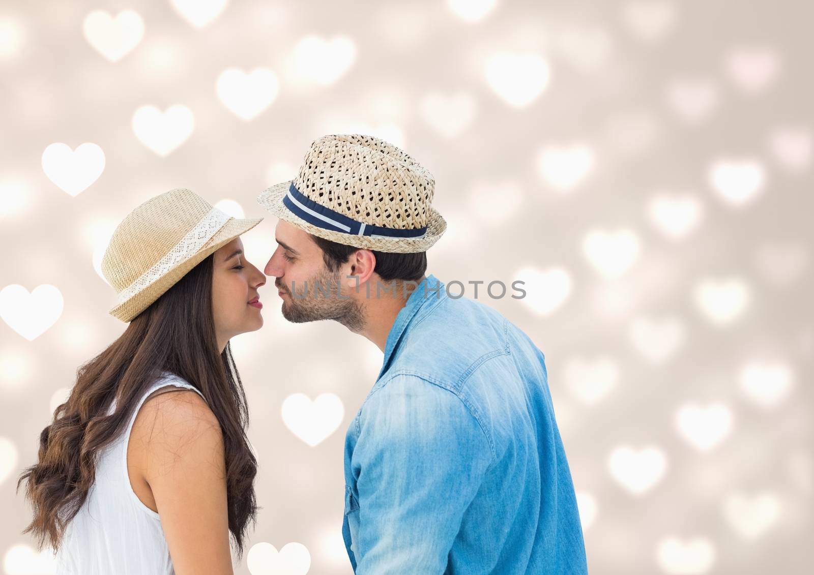 Romantic couple kissing each other against digitally generated heart background
