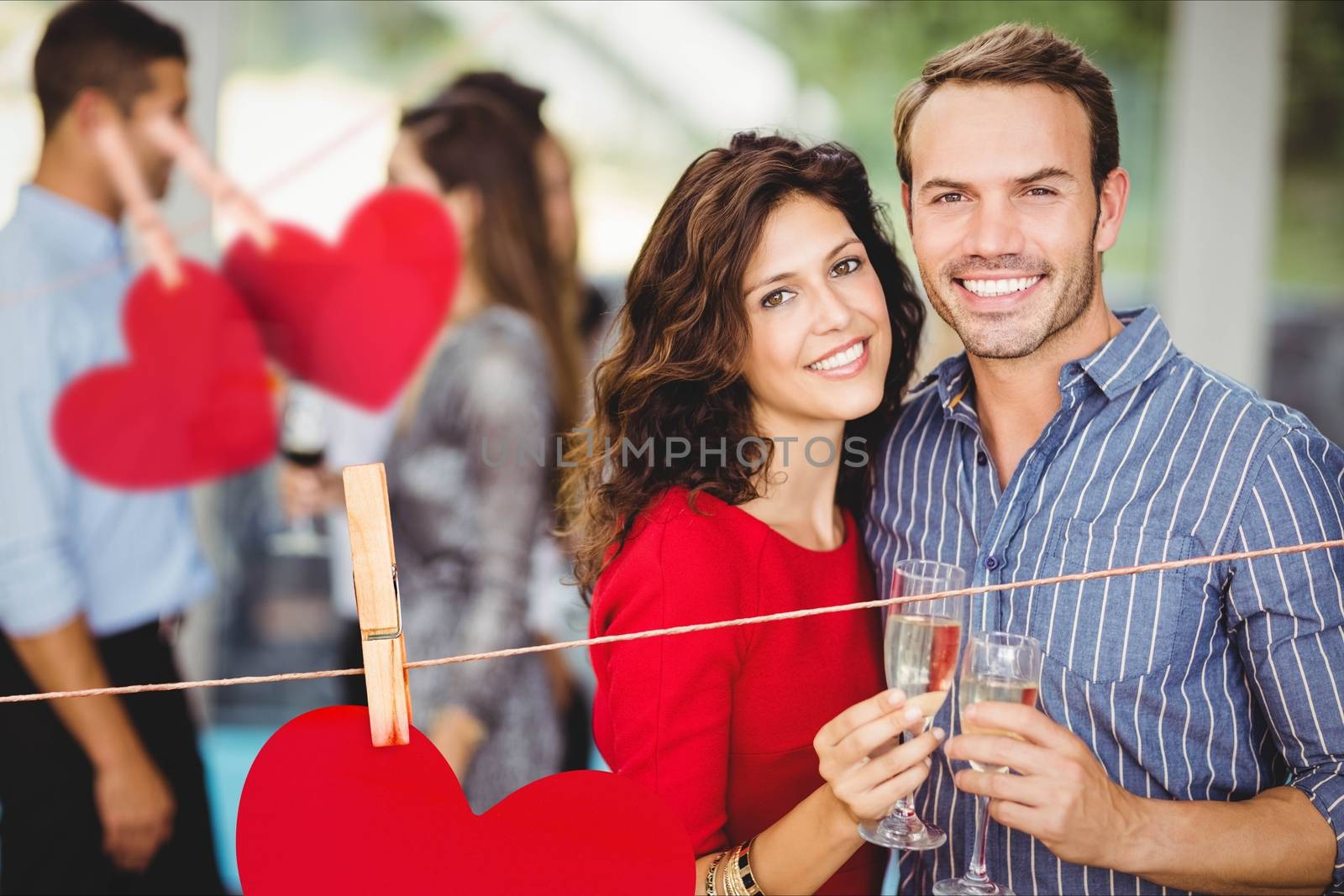 Portrait of romantic couple standing with a glasses of champagne