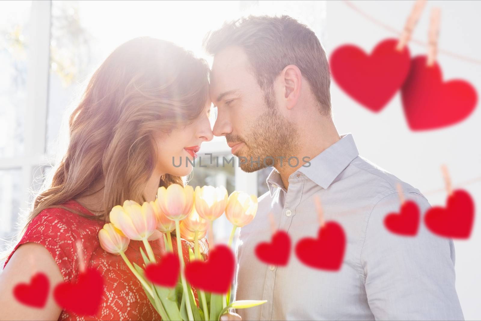 Romantic couple embracing each other with red hanging hearts