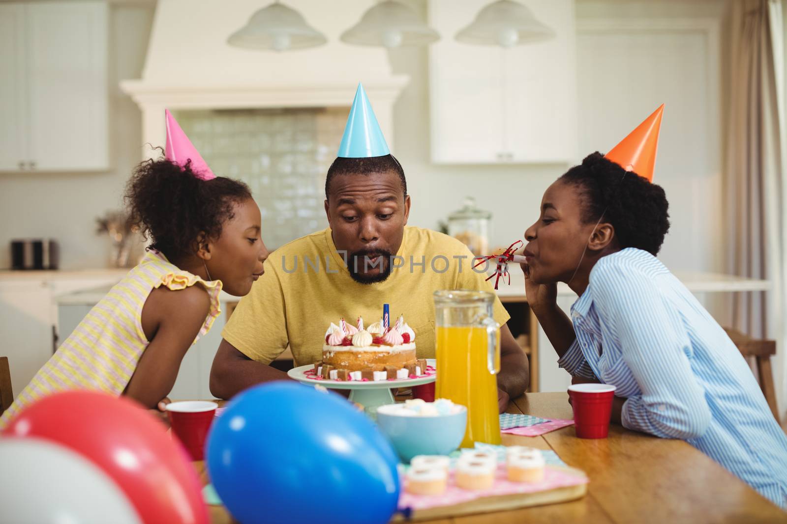 Family celebrating a birthday at home
