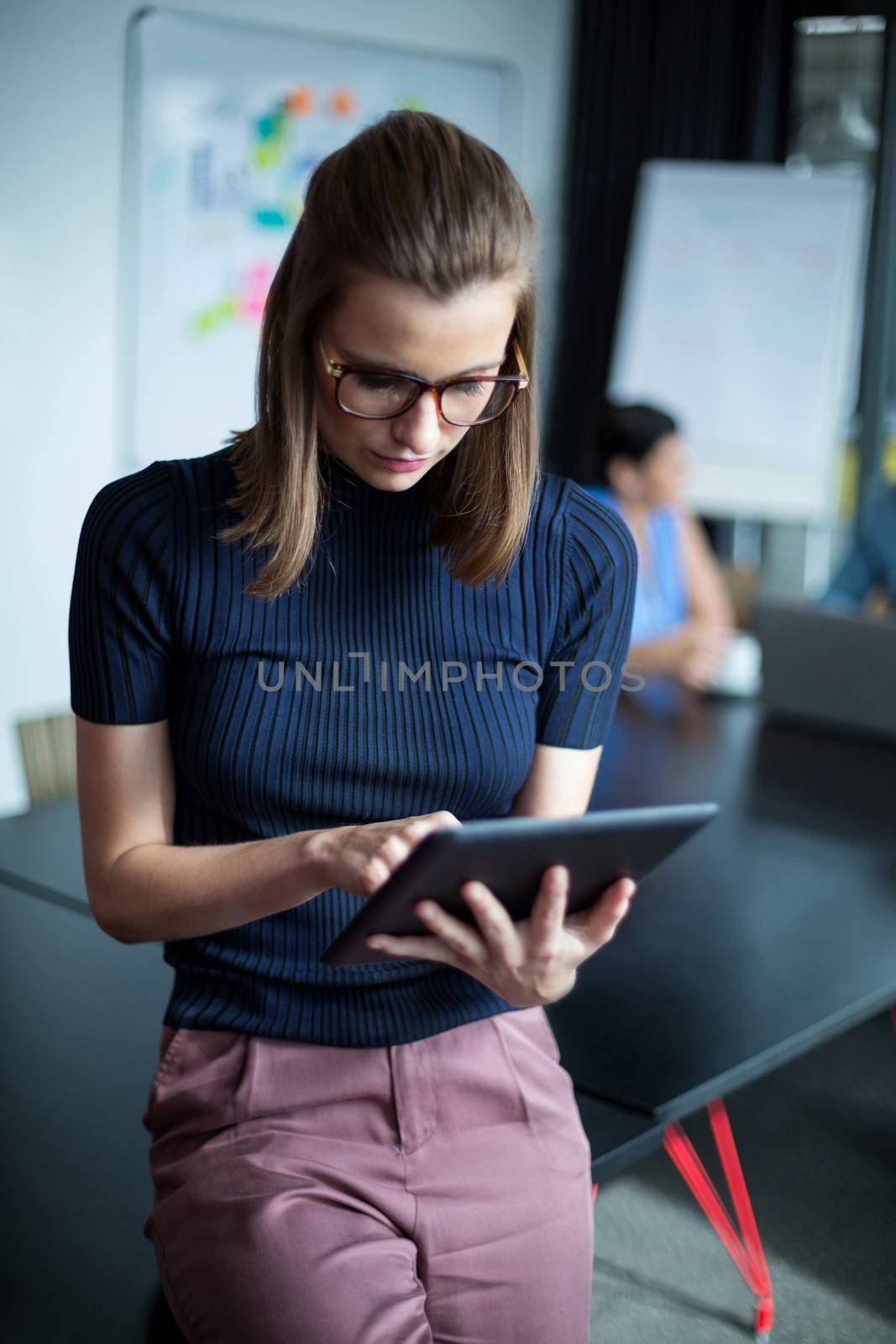 Attentive business executive using digital tablet in office