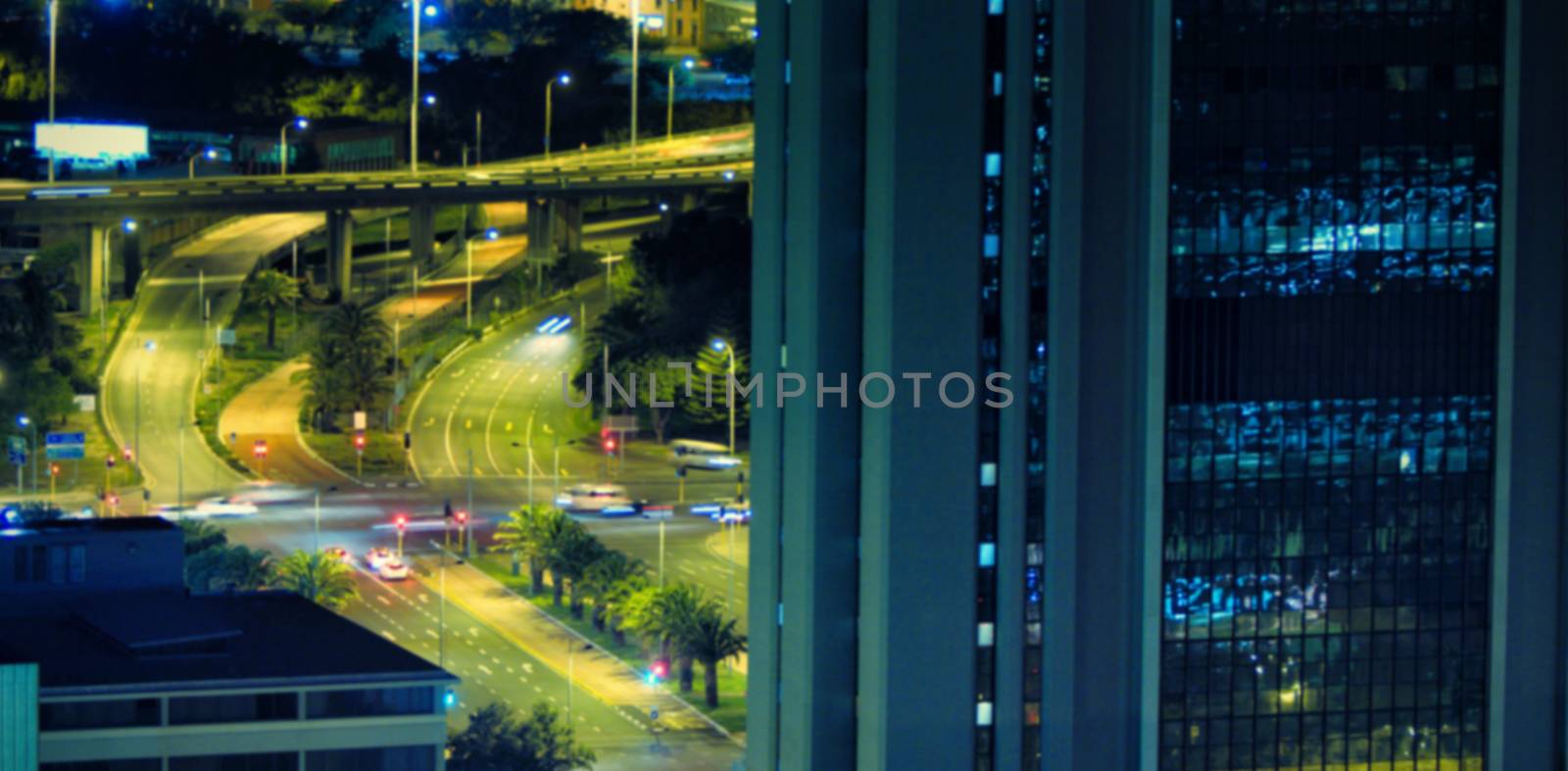 Cars moving on road seen through window at night