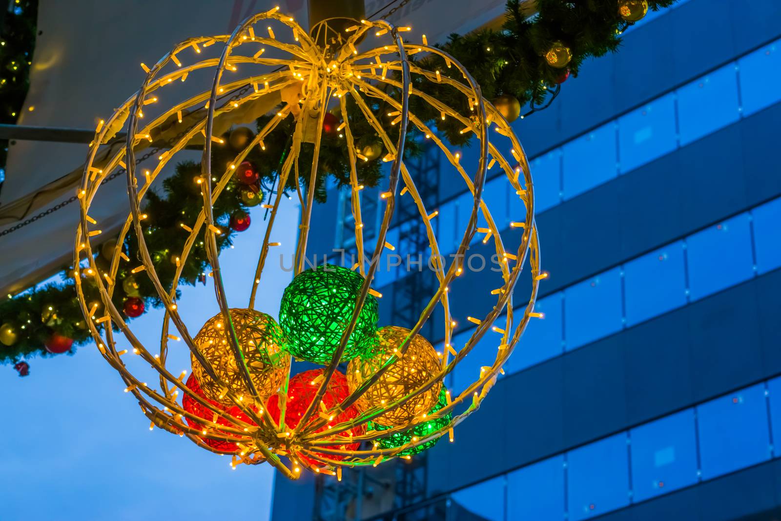 Beautiful lighted christmas decoration hanging in the city, Seasonal Tradition