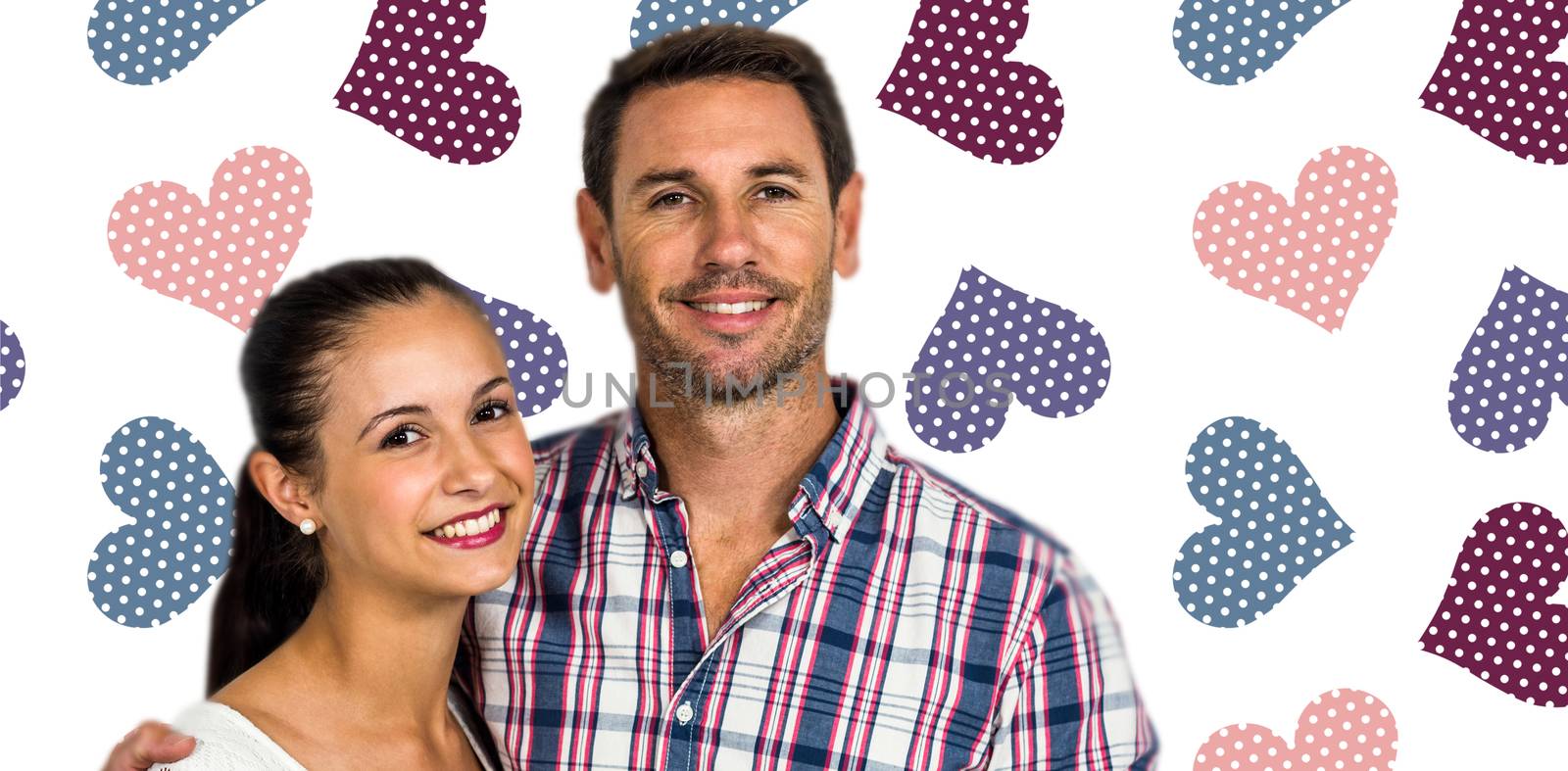 Portrait of smiling couple looking at camera against background with hearts