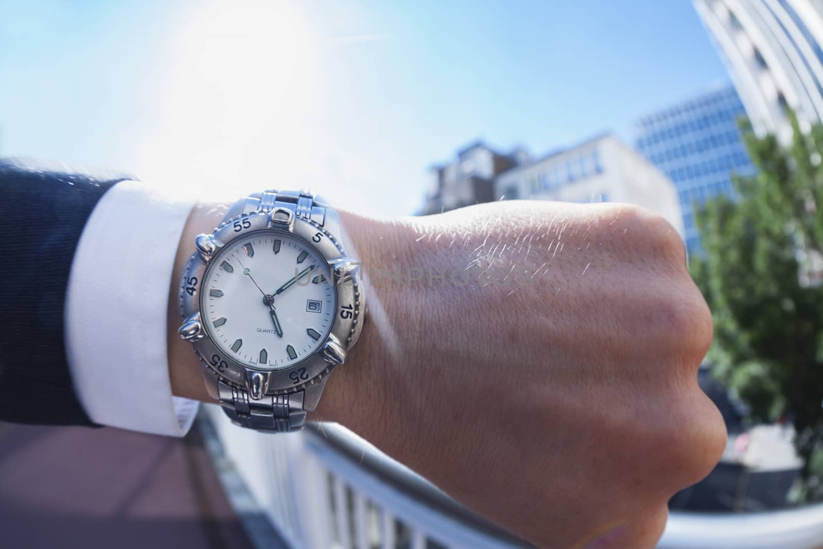 Personal perspective of a caucasian businessman looking at his wristwatch