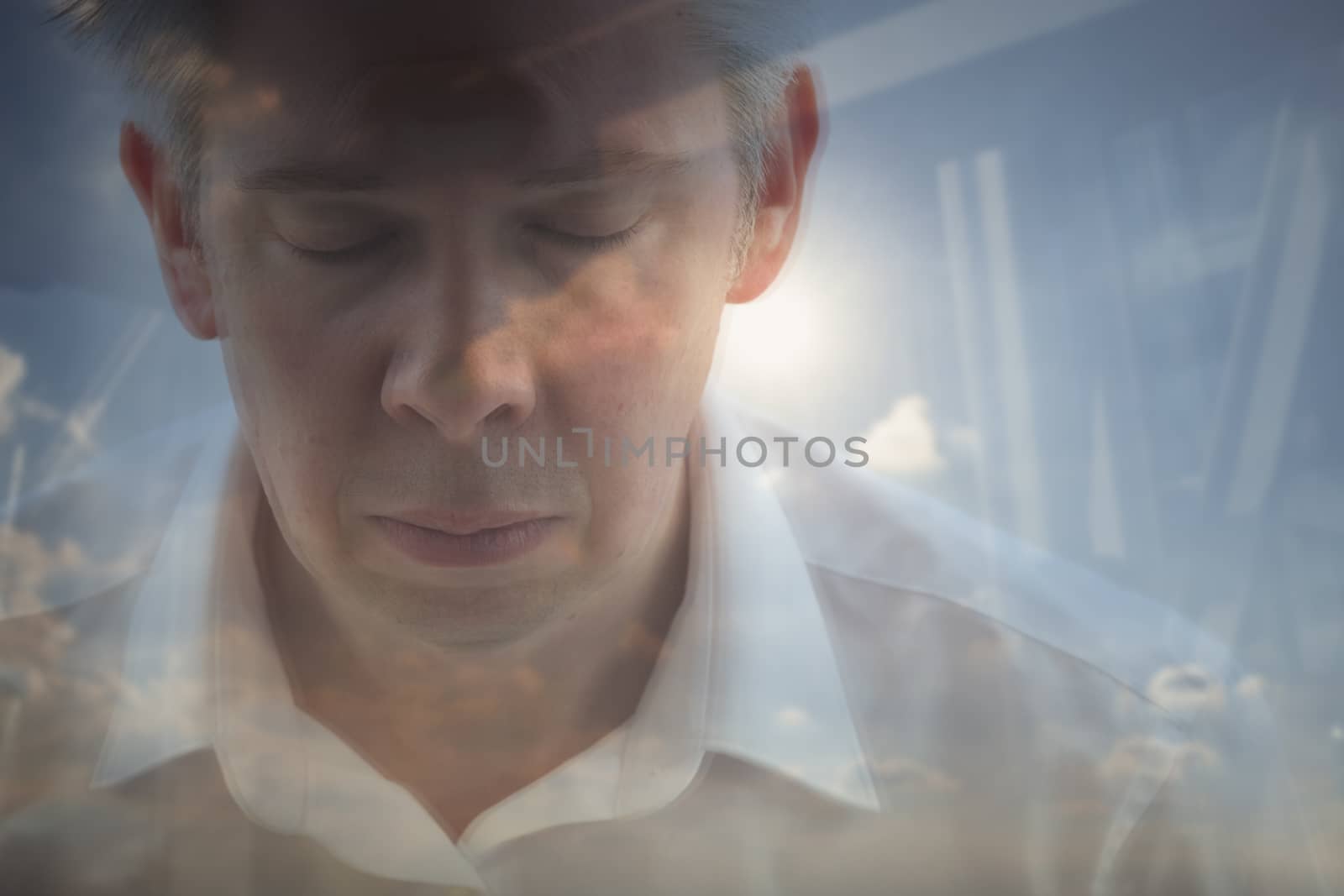 Elevated view reflection of a caucasian businessman looking out of an office window themes of stress deadlines contemplation