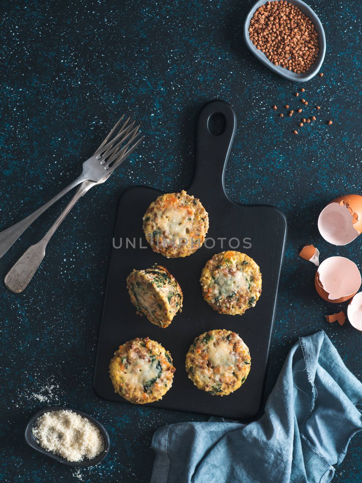 Buckwheat casserole with spinach,carrot,parmesan.Baked eggs with buckwheat,vegetables and cheese.Ideas and recipes healthy easy breakfast,lunch,kids meal,snack - vegetables muffins.Copy space.Top view