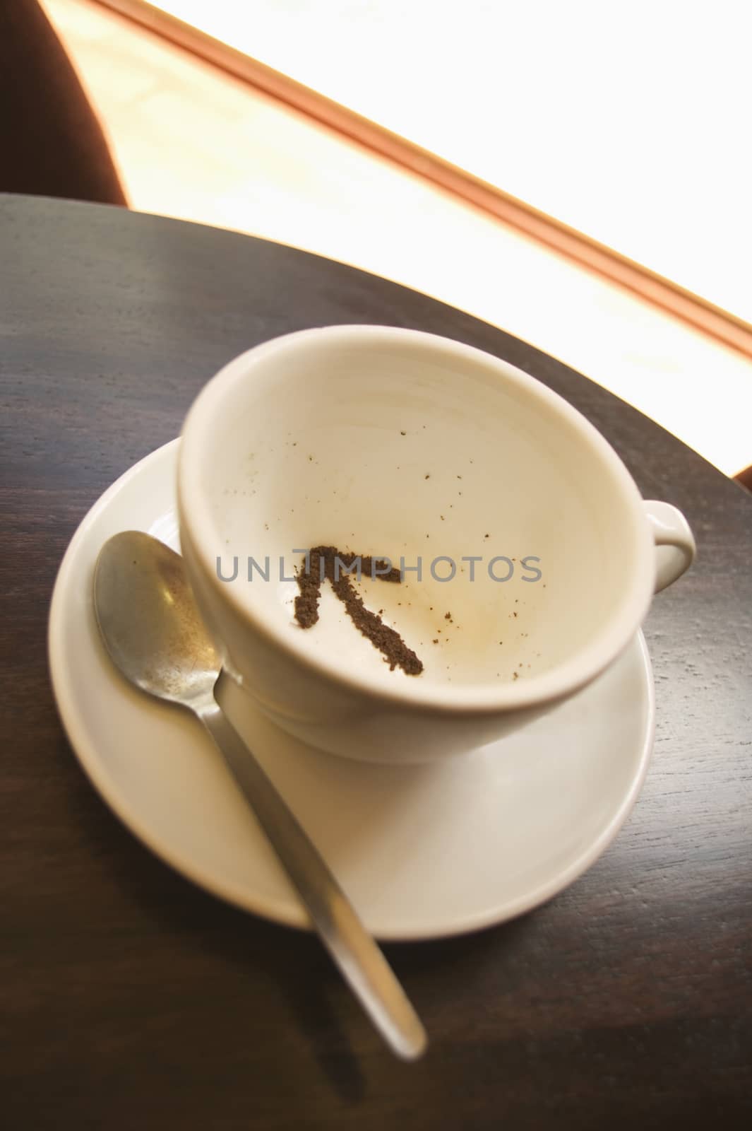 Tea leaves in a tea cup in the shape of an arrow themes of future direction decision