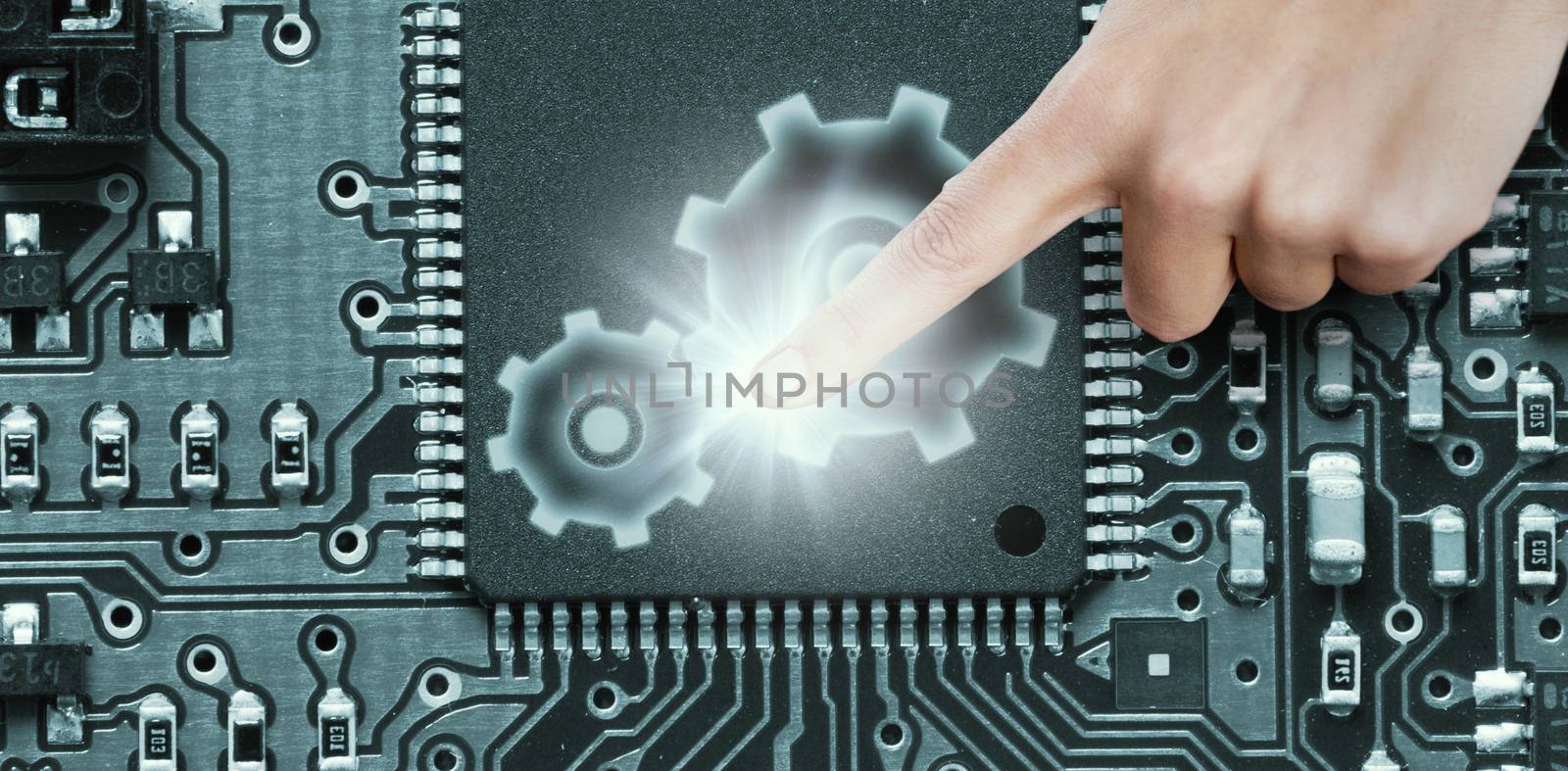 Close-up of human hand pointing against blue electronic circuit