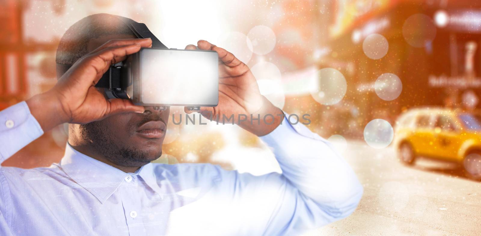 Man holding virtual reality headset against blurry new york street