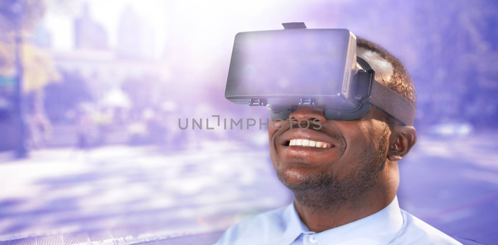 Happy man using virtual reality headset against blurred new york street