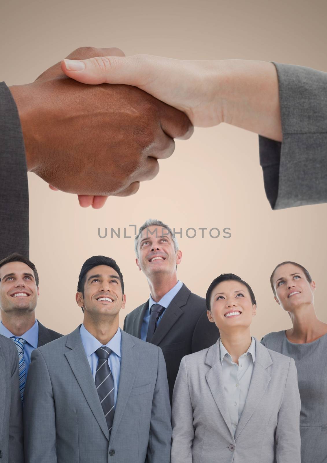 Composite image of Handshake over business people and cream background by Wavebreakmedia
