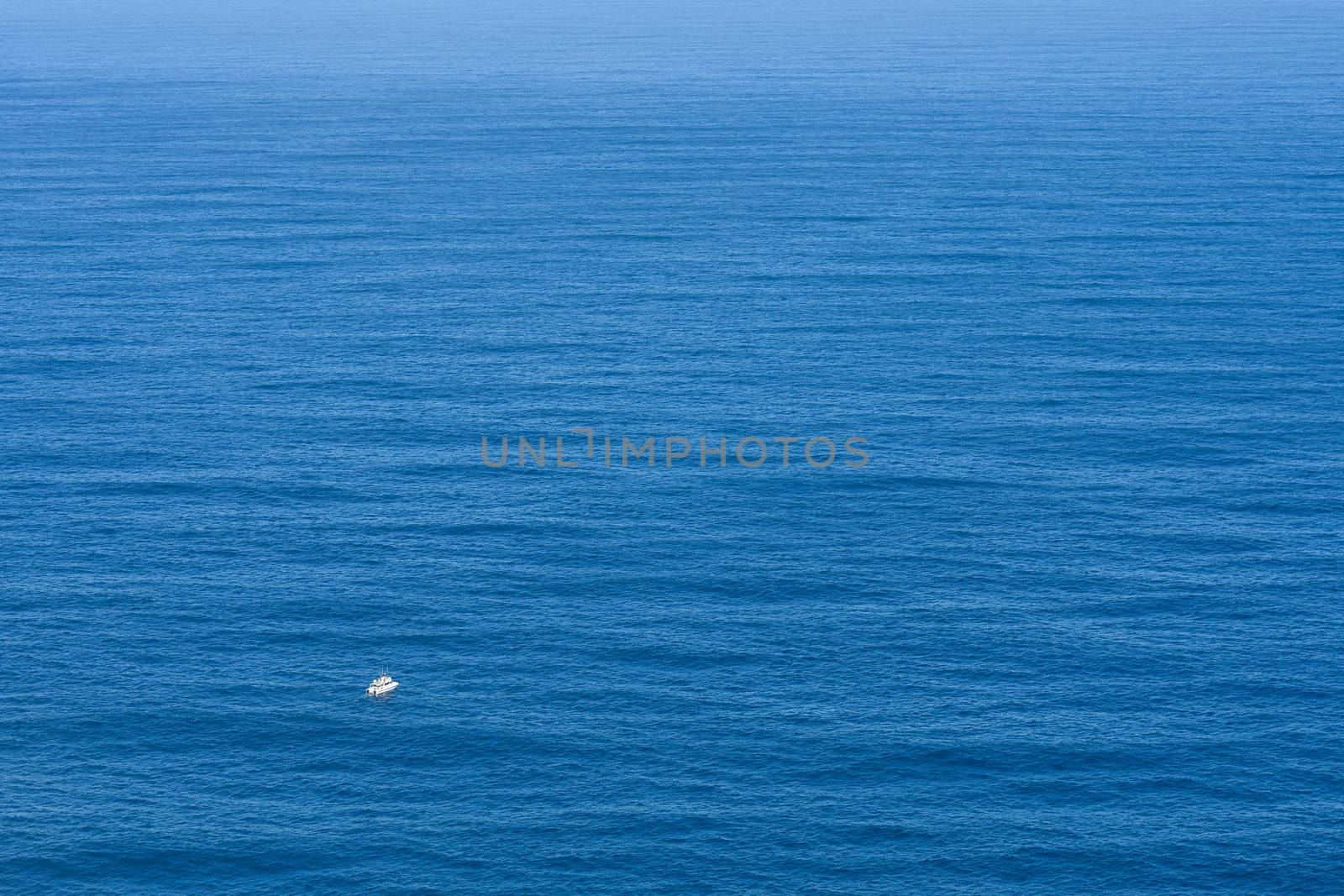 A small powerboat facing the endless vastness of open ocean, Cape Town, South Africa